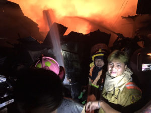 Firefighters at the scene of the fire in the capital's Khlong Toey district (Picture: Khaosod English)